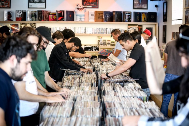 People vinyl digging at a record store