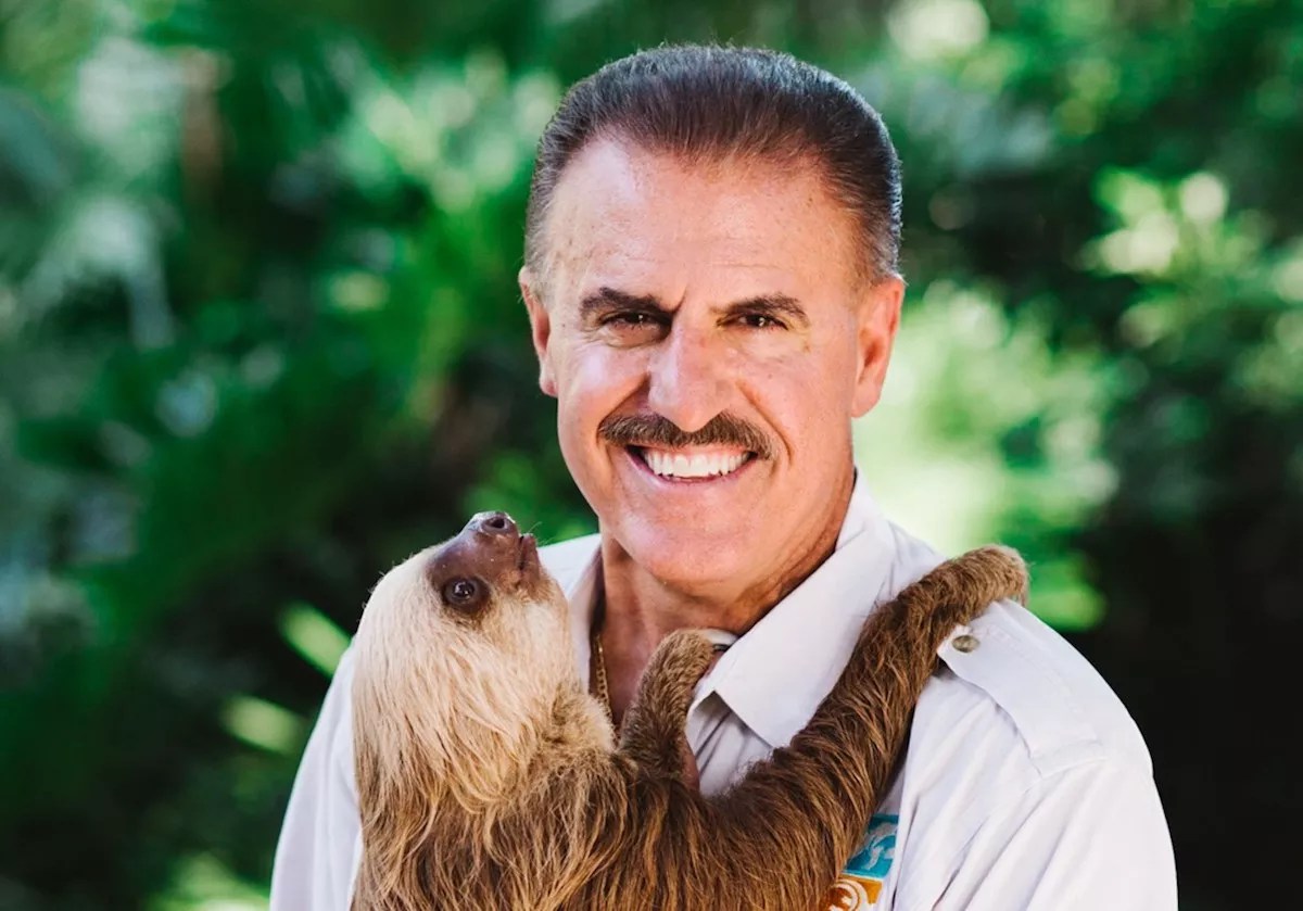 headshot of conservationist Ron Magill holding a sloth