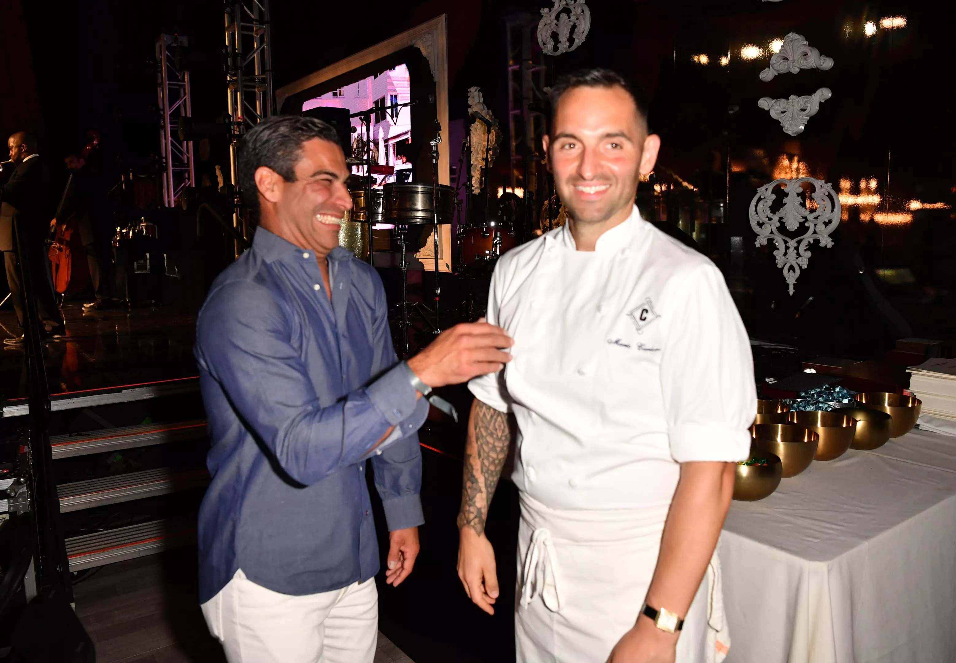 Miami Mayor Francis Suarez laughs while standing next to a popular chef