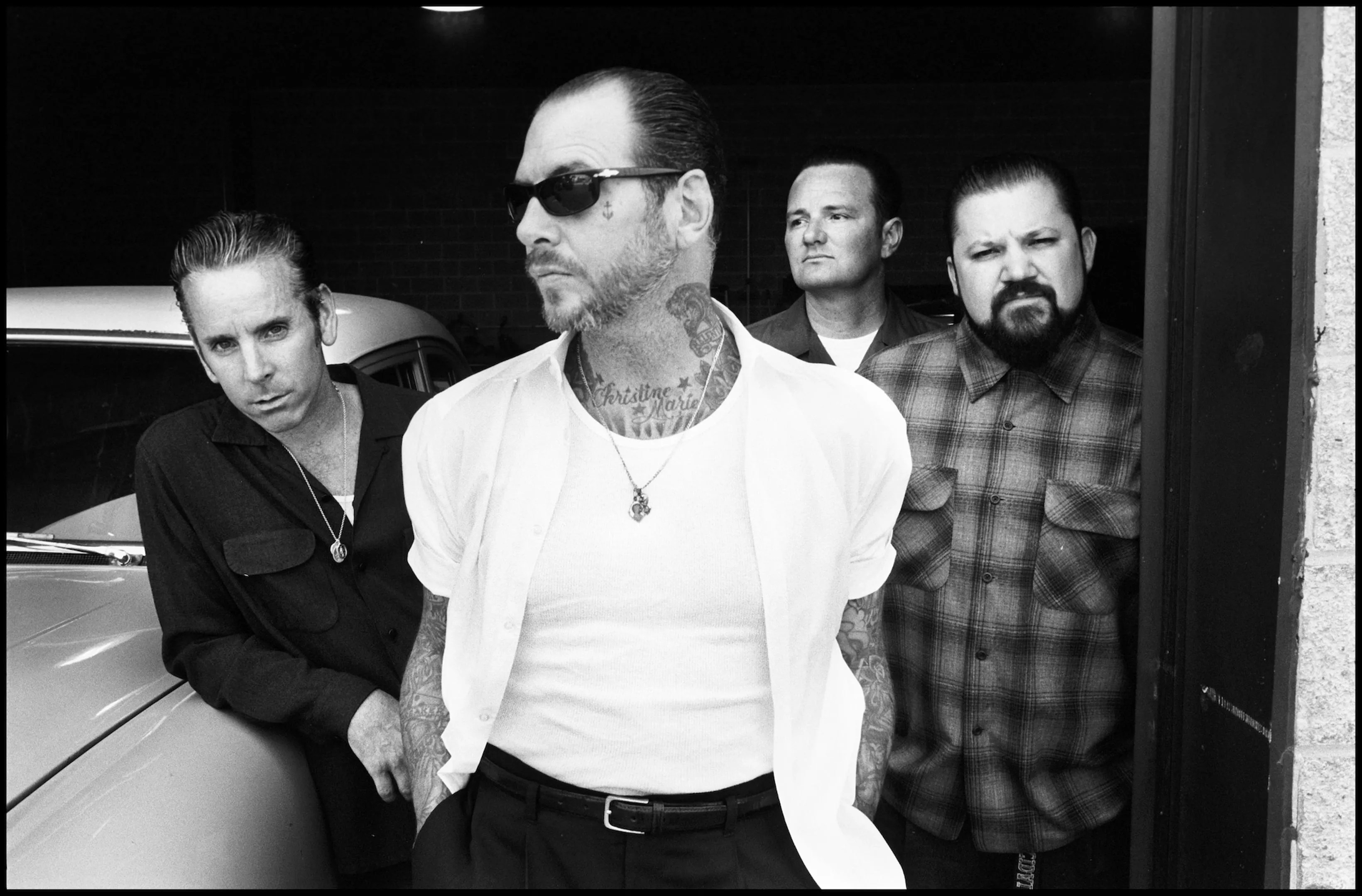 Black and white image of the four members of the punk band Social Distortion