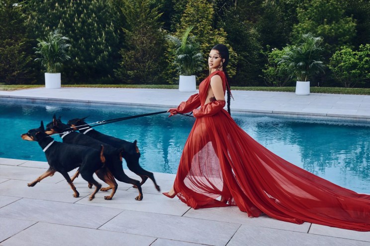 Cardi B in a red dress in front of a pool