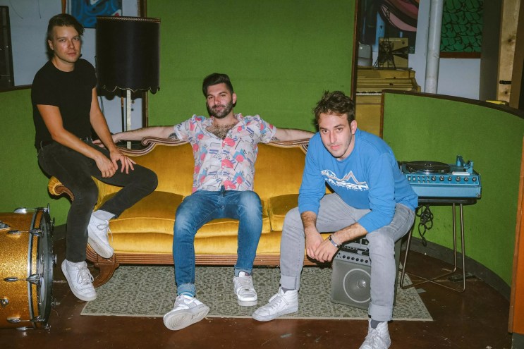 The members of the Magic City Hippies sitting on a couch