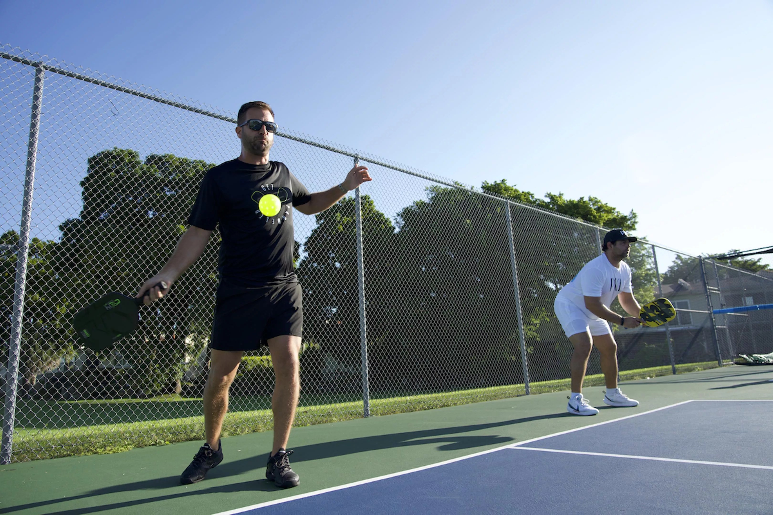 Two pickleball players standing on a court