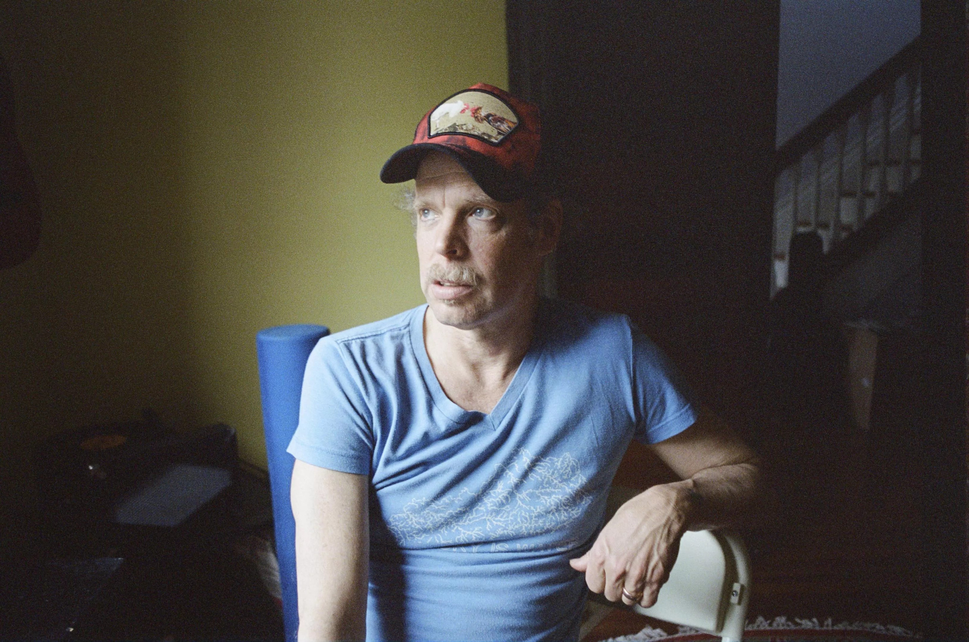 Bonnie "Prince" Billy in a light-blue shirt and baseball cap