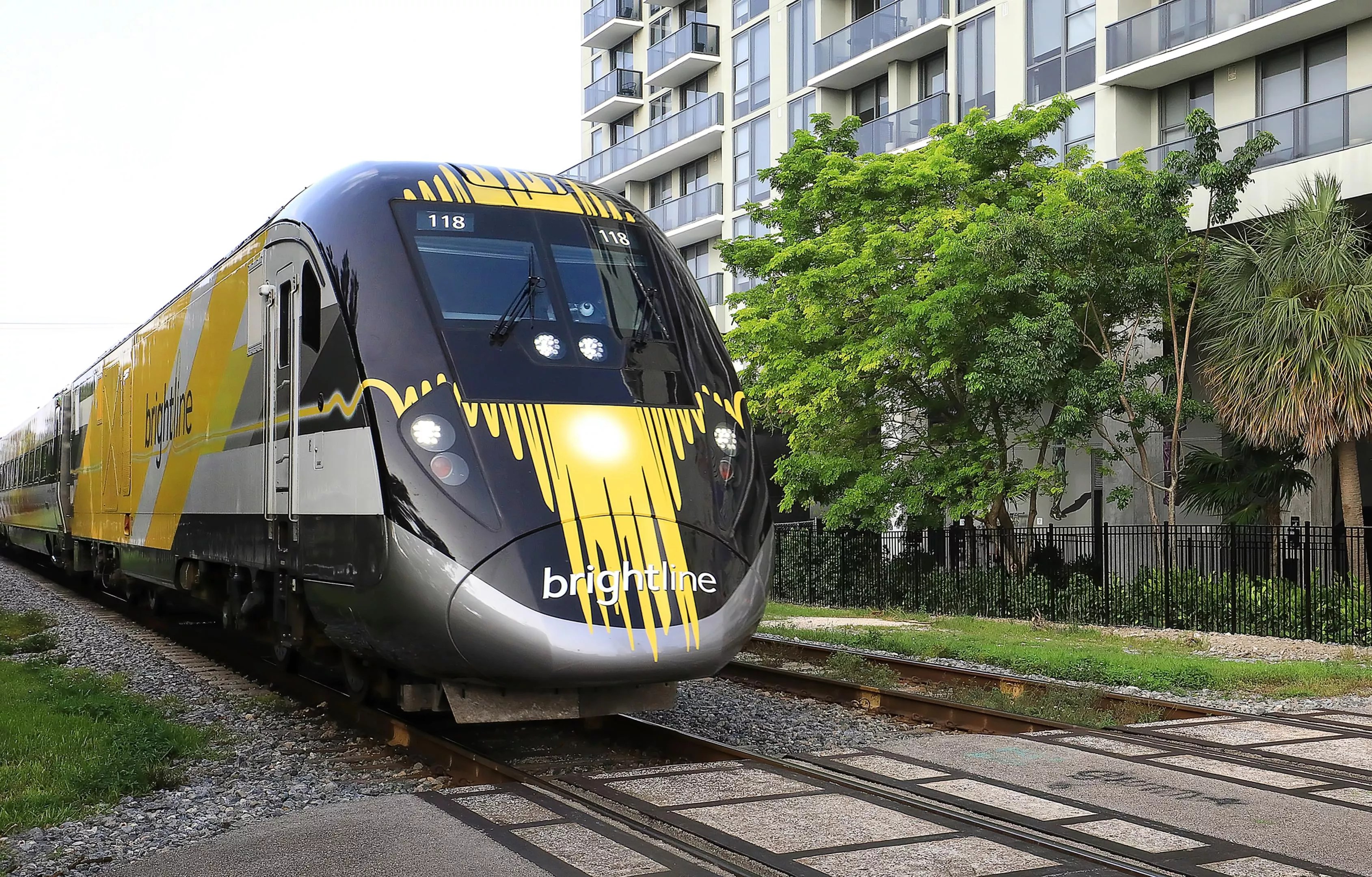 A Brightline passenger train chugging down the tracks