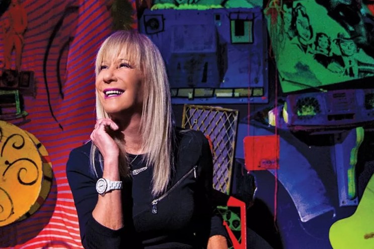 Mindy Shrago smiles against a colorful backdrop