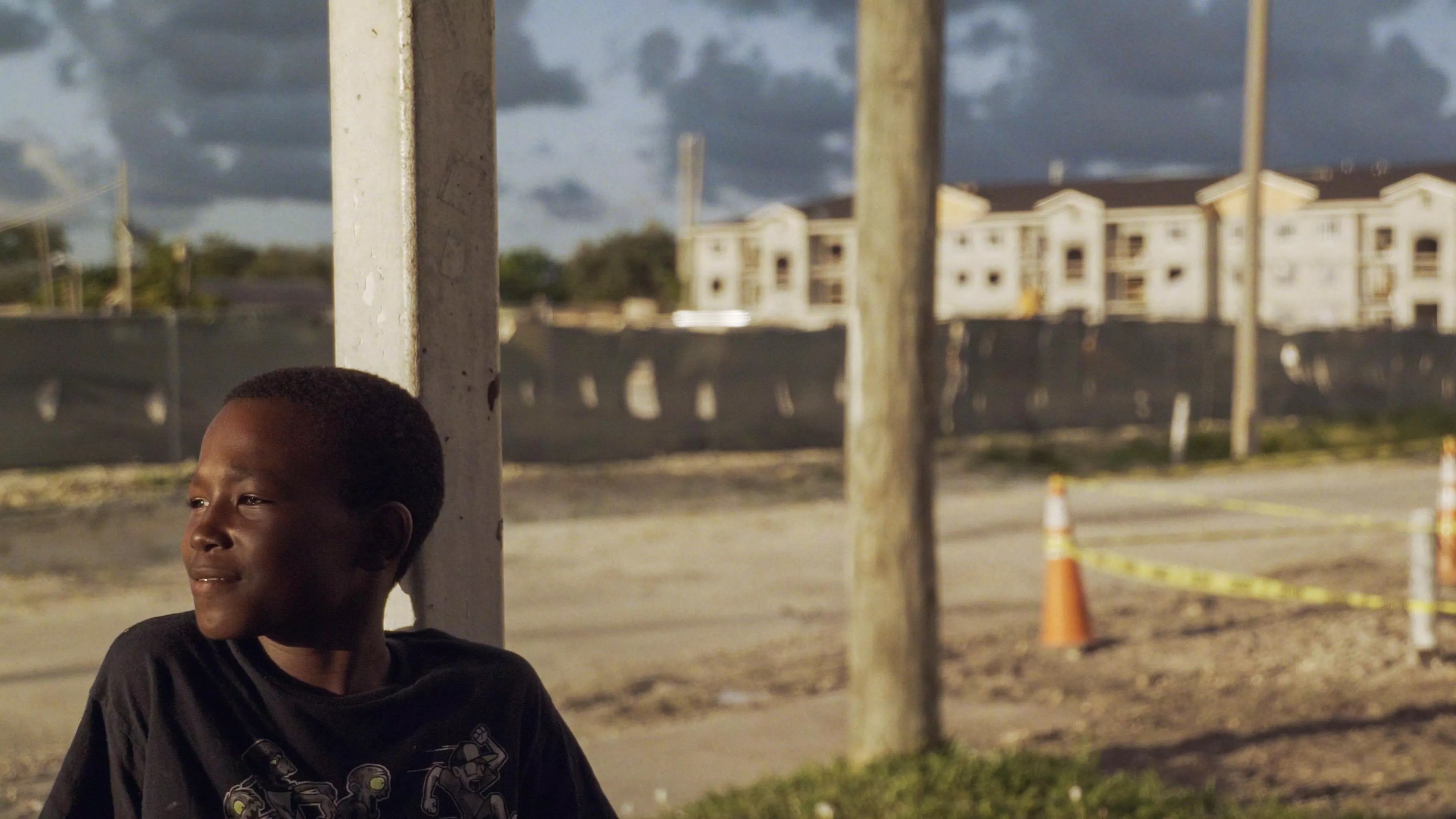 A child stands on the porch of his home in Liberty Square