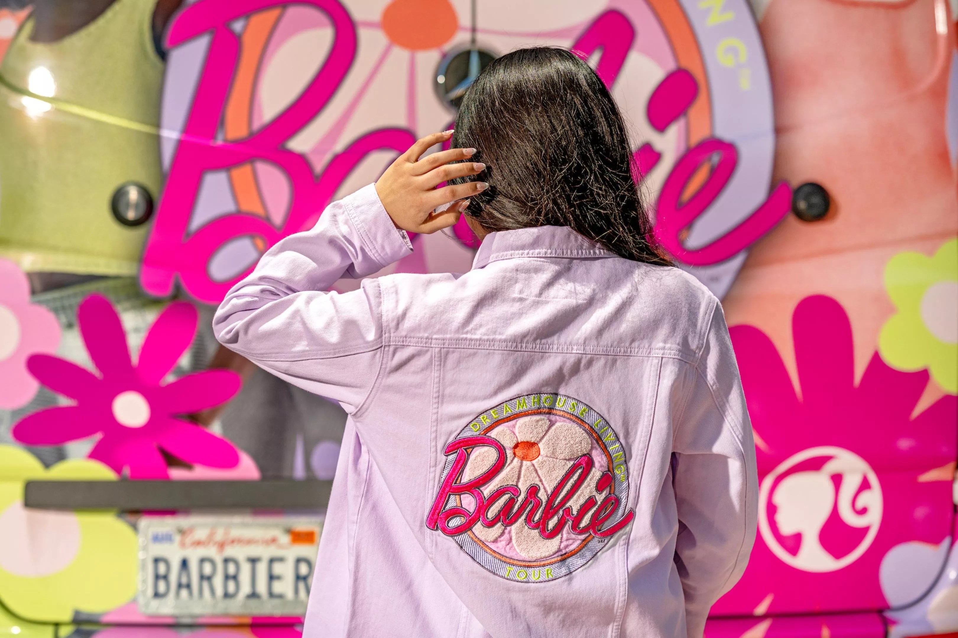 Model wearing Barbie-embroiders denim jacket