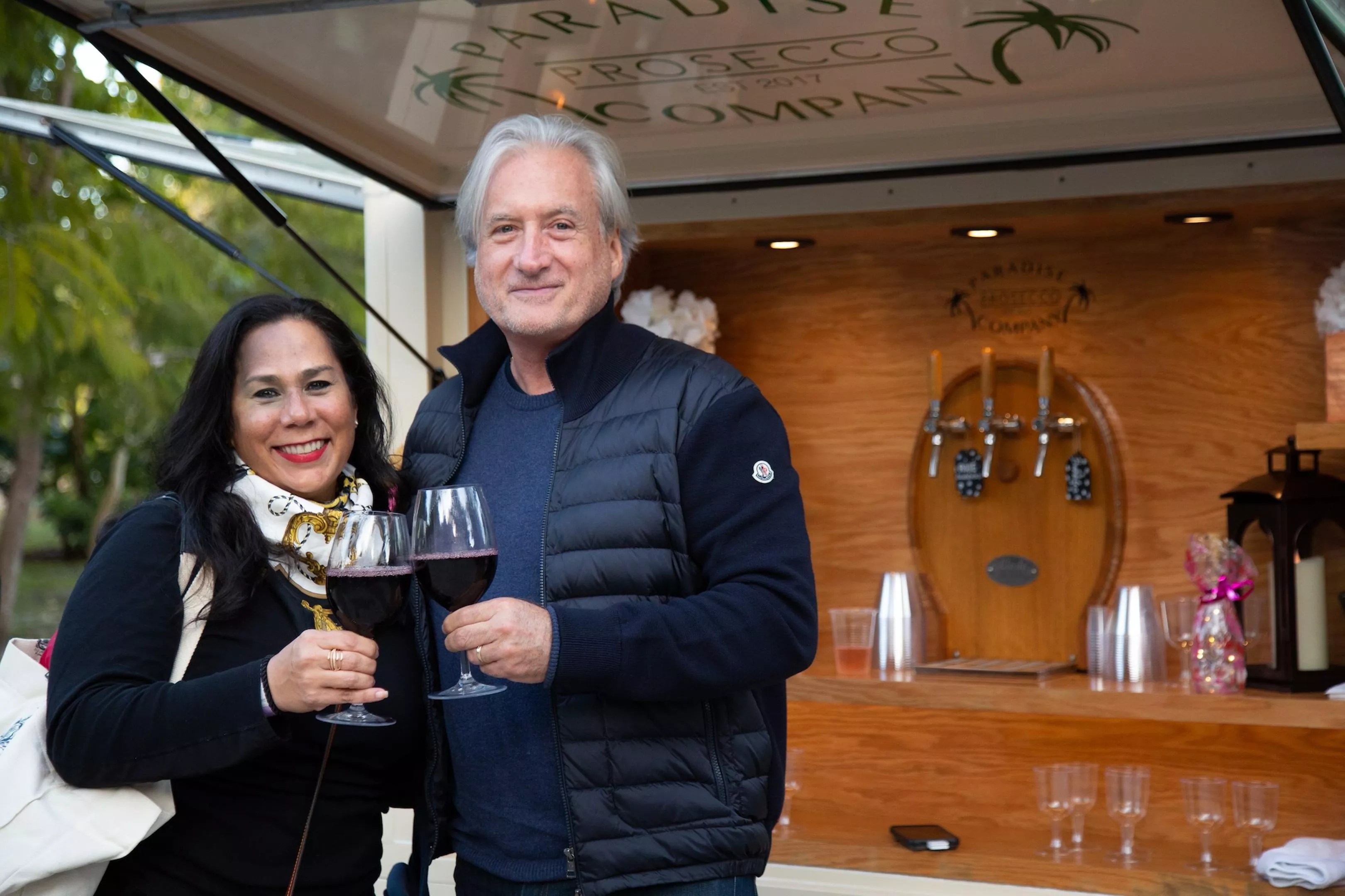 A couple toasting with a glass of win