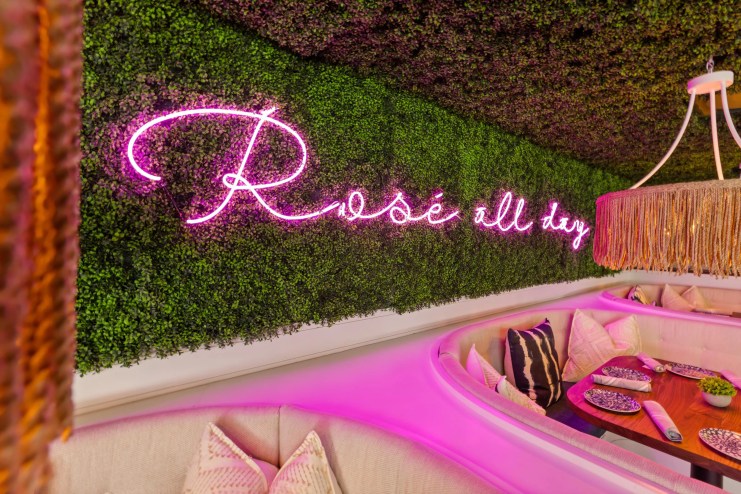A pink neon sign that reads "Rosé all day"