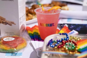 A pink cocktail and rainbow beads