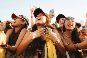 A woman holds a flag as she looks at what is happening on stage