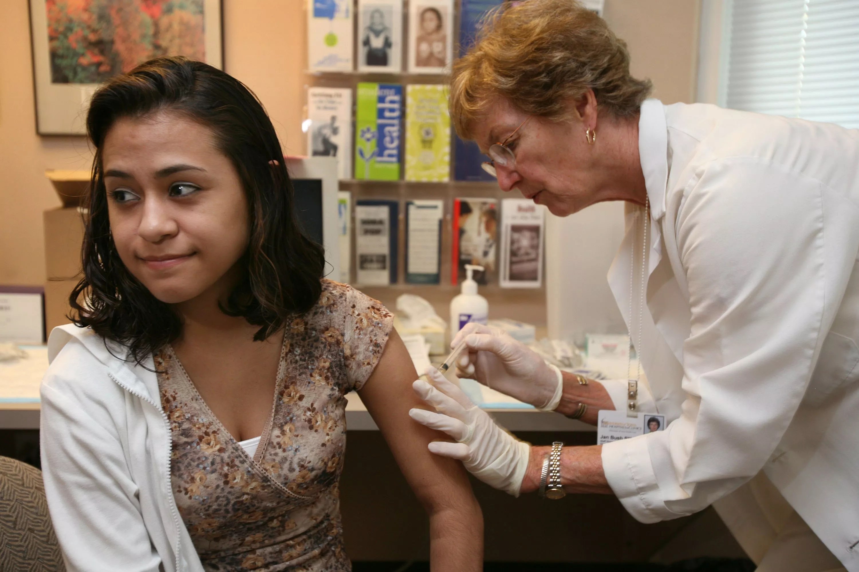 A college student receives a vaccination at a clinic