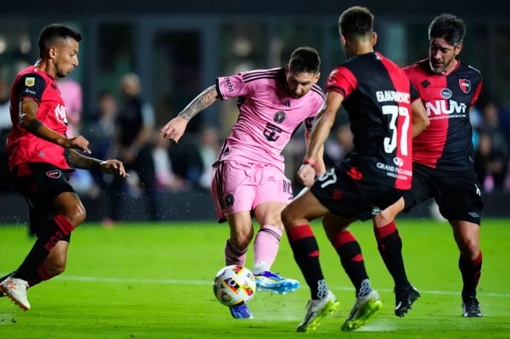 Soccer legend Lionel Messi shoots the ball during a home game against Newell's Old Boys