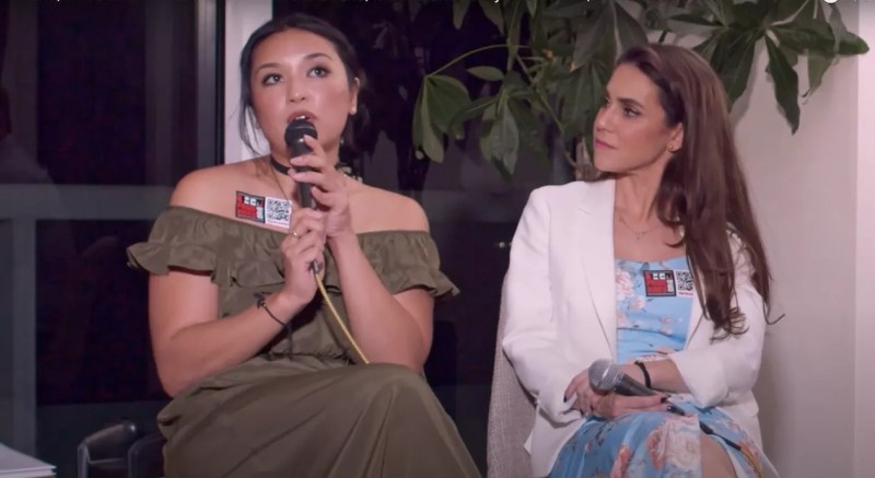 Crypto currency promoter Eryka Gemma holds a microphone while attending a podcast talk with politician Martha Bueno