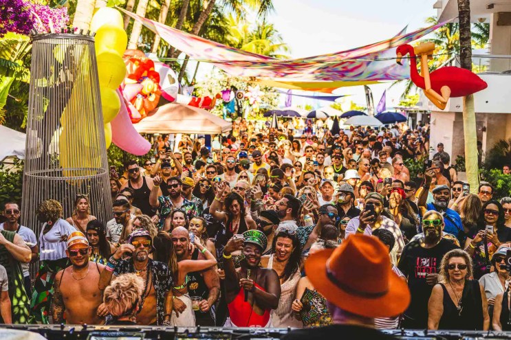 Partygoers dancing at the Glitterbox pool party