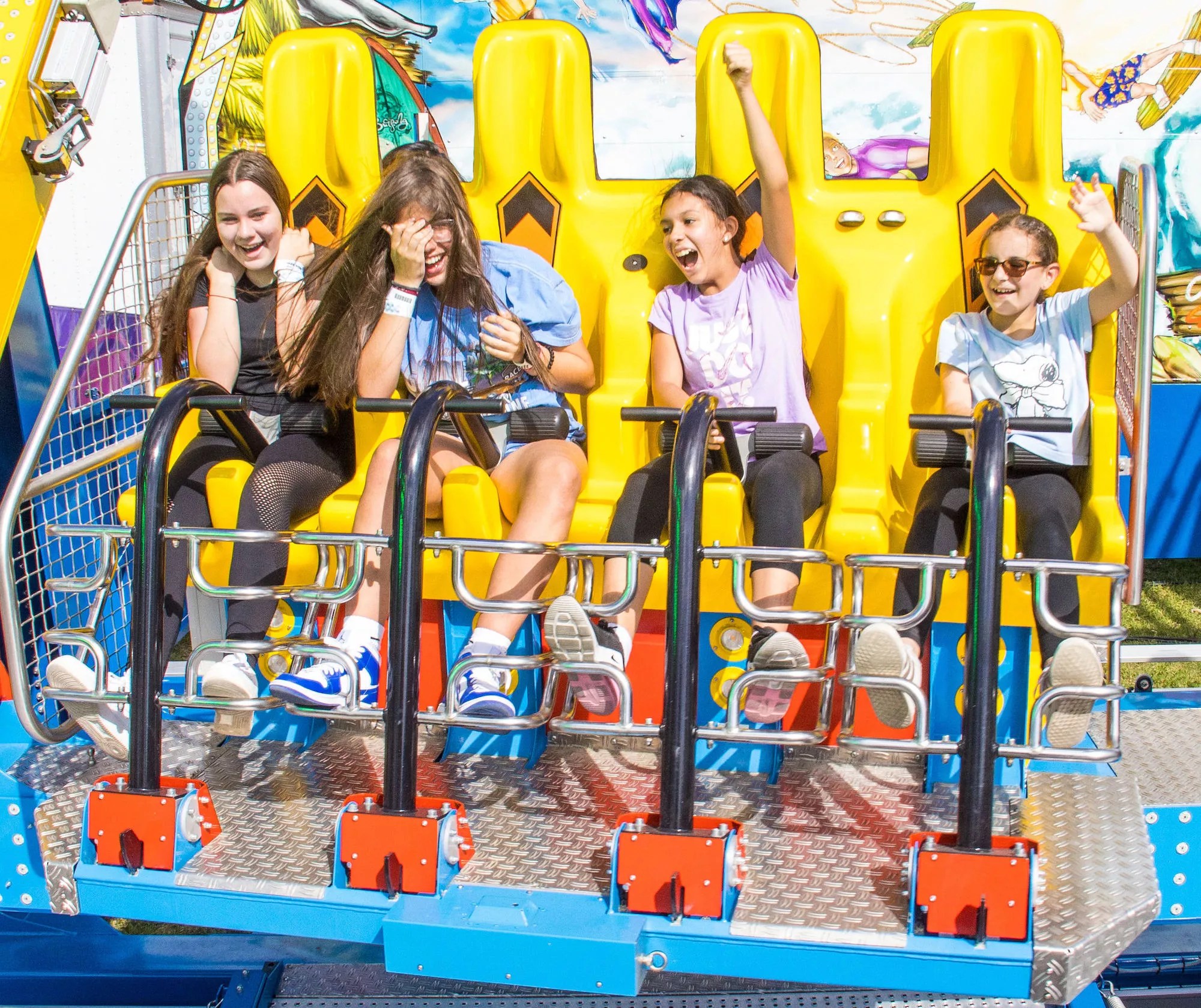 Four young girls on a carnival ride