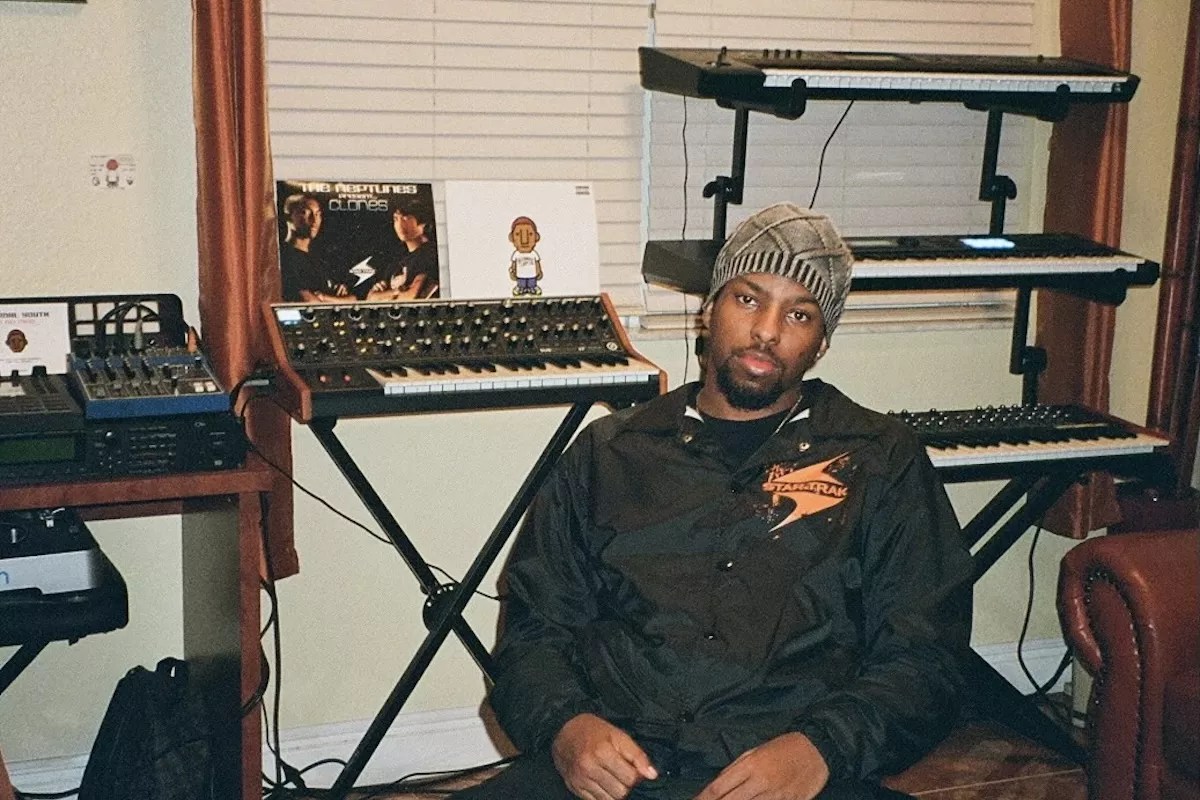 Justin Wiggins sitting in a chair in his studio