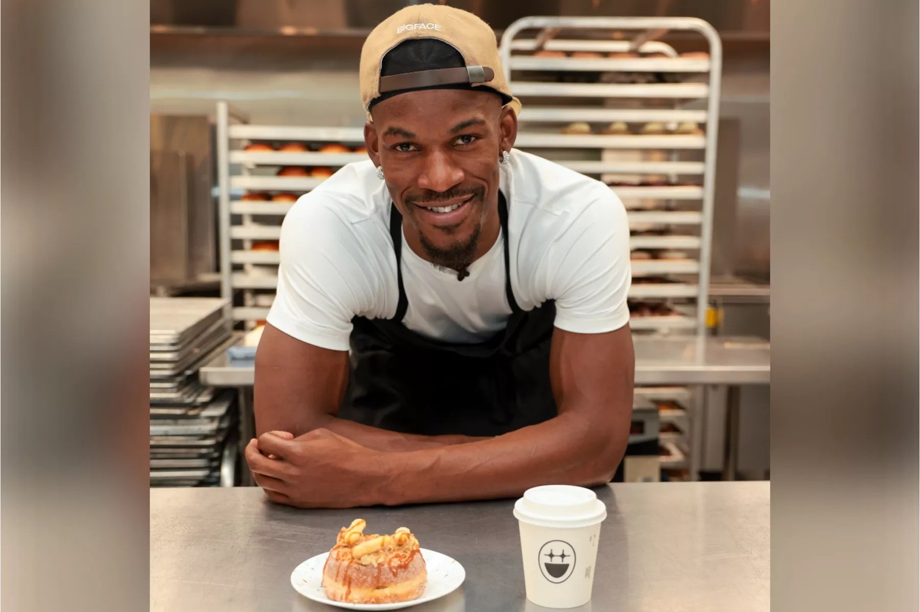 A man posing with a doughnut