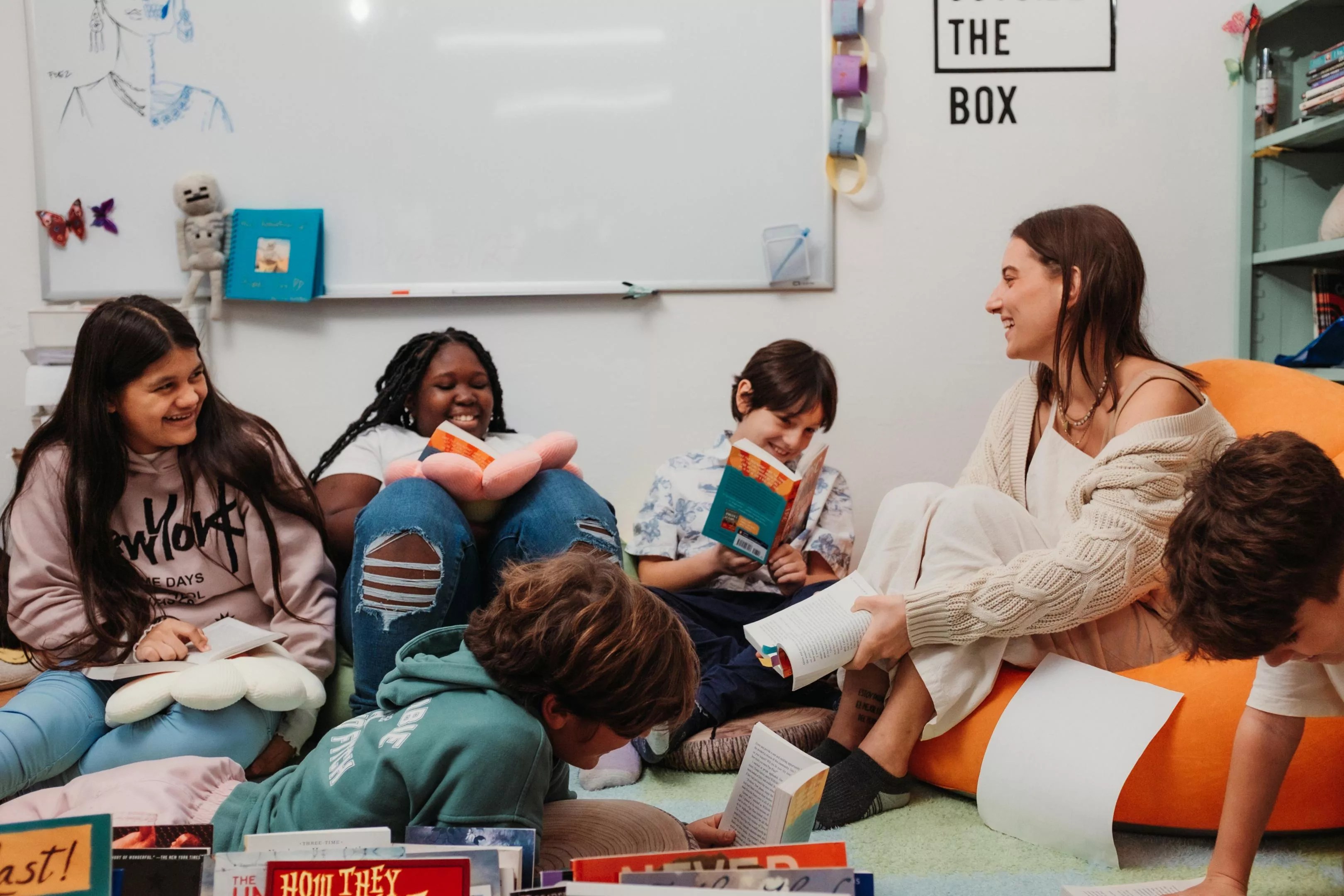 A teacher reads to smiling students at Primer Health District microschool.
