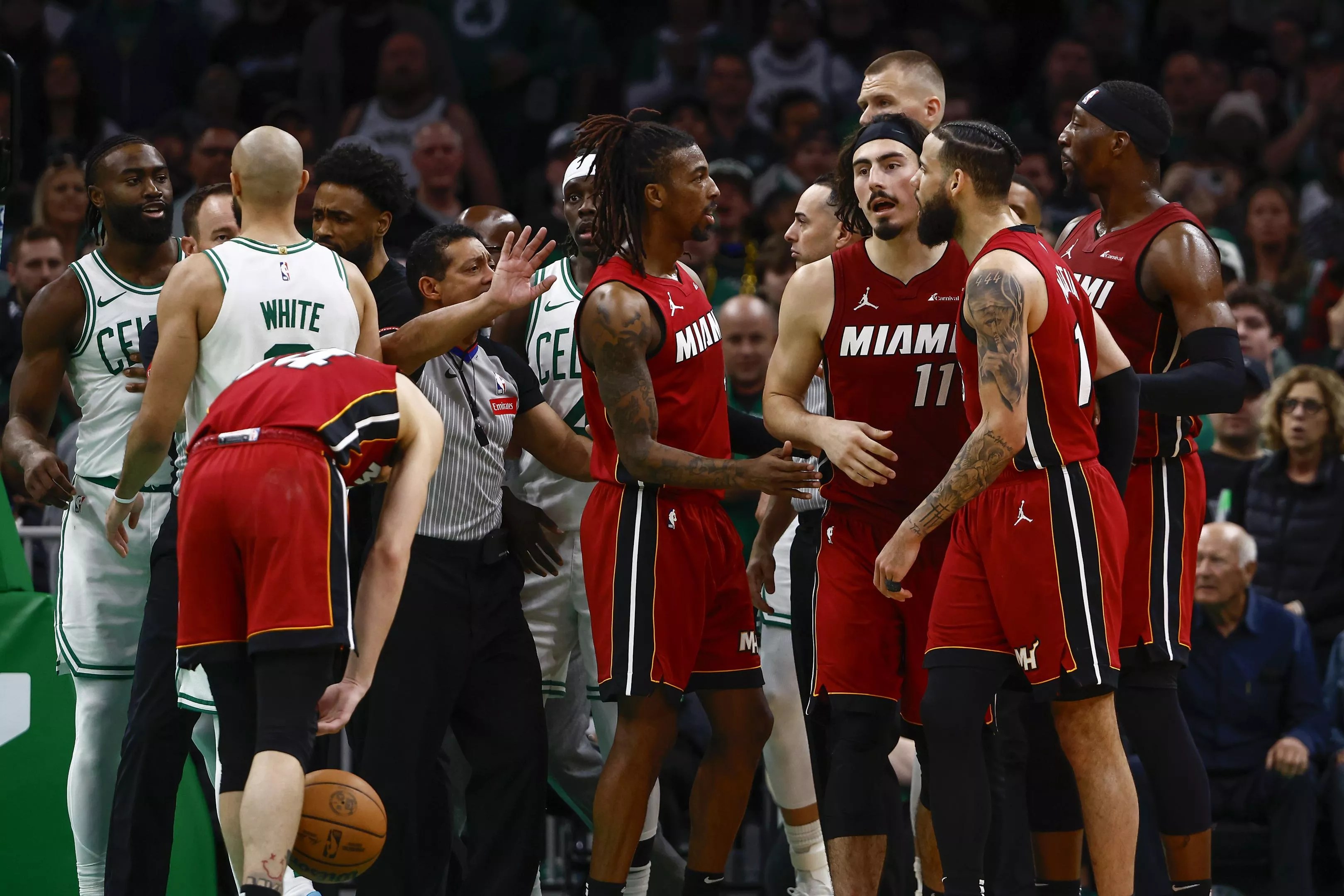 Tension builds on the court as Miami Heat and Boston Celtics exchange words after a hard foul