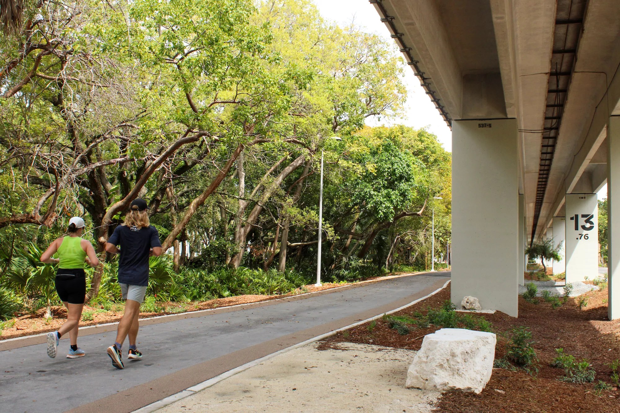 Two people jogging along a path of the Underline