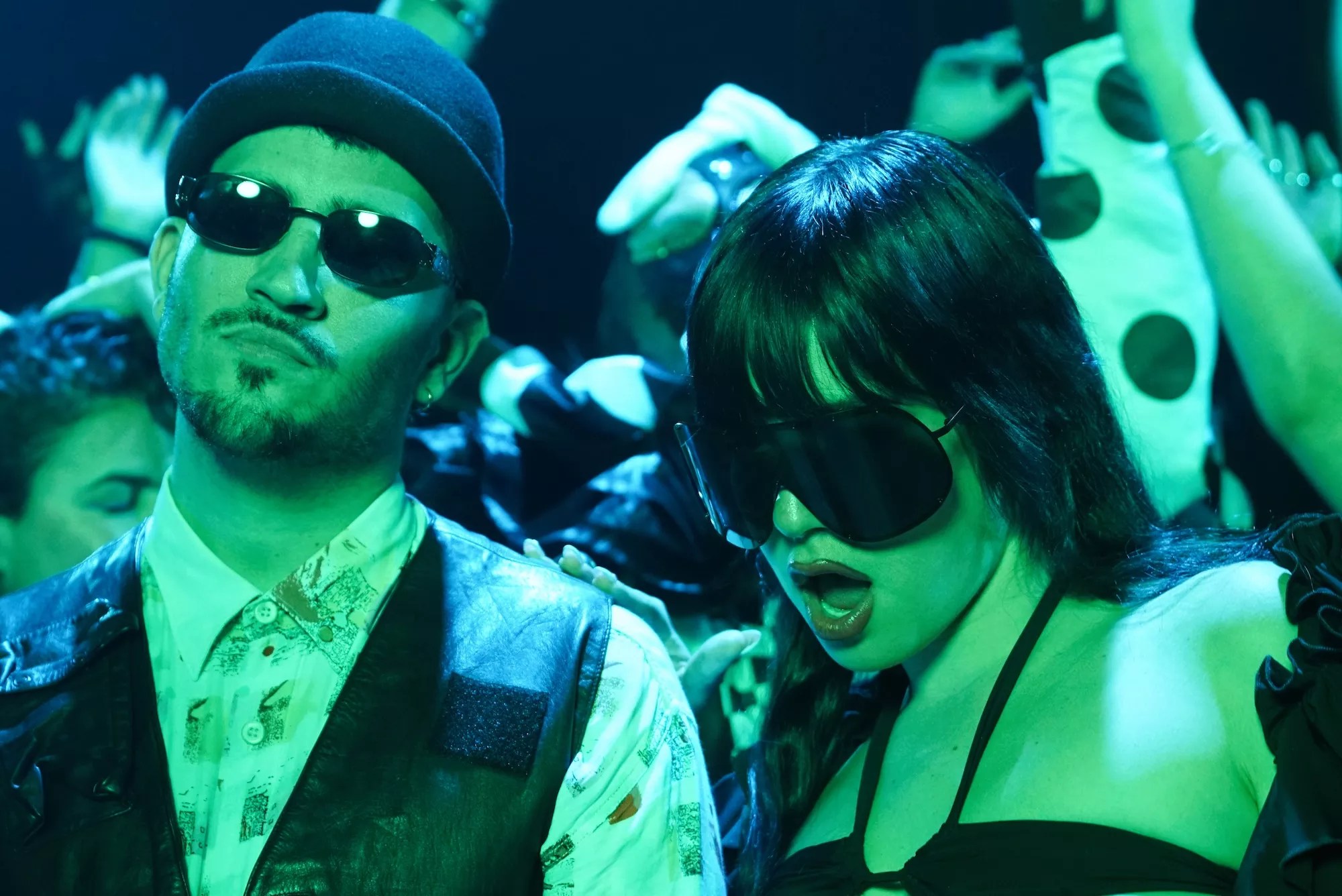 Danny From Miami and MJ Nebreda in a crowd, awash in a green light