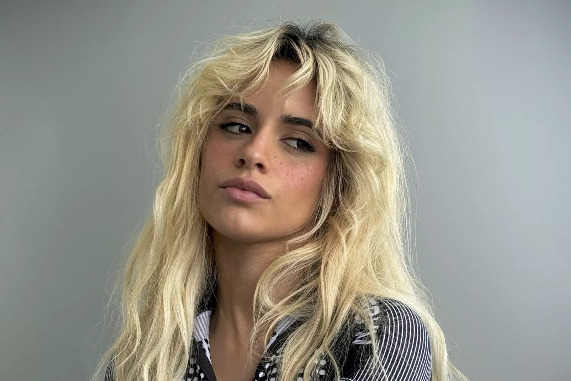 Portrait of Camila Cabello against a gray background