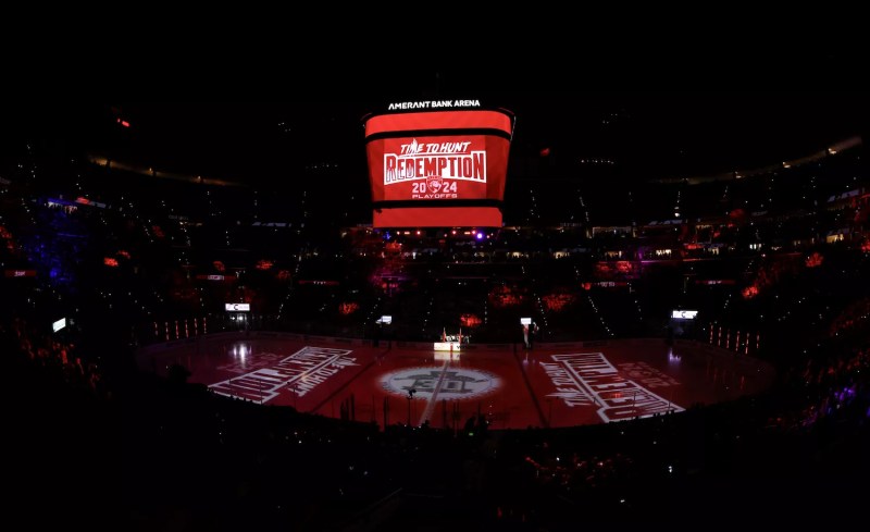 a darkened Amerant Bank Arena with "Redemption" illuminated in white on red on the ice and on the overhead scoreboard