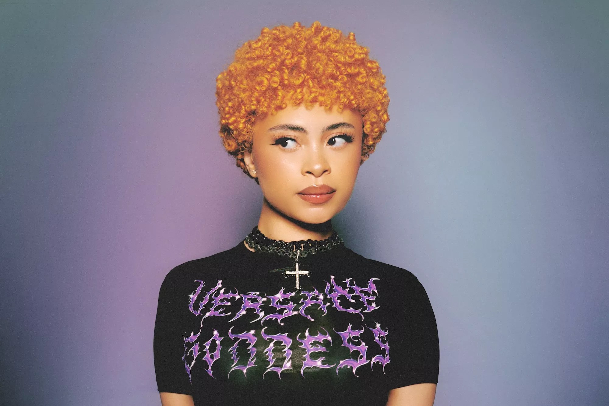 Portrait of Ice Spice in a bright orange Afro