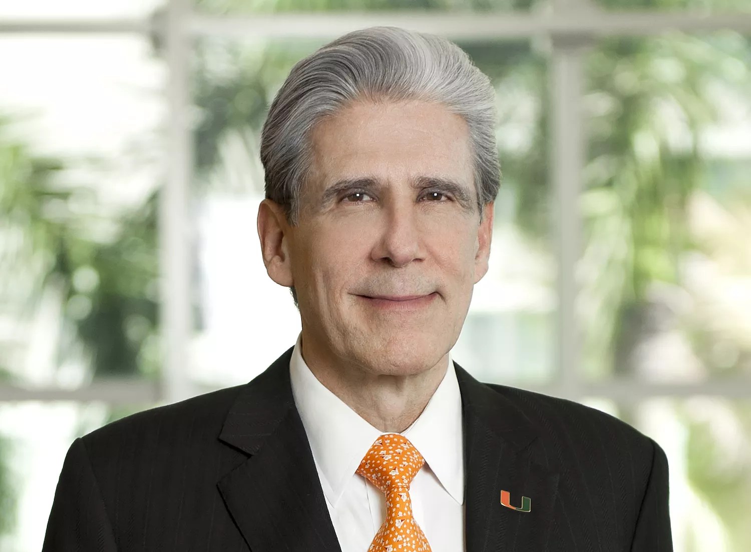 a 2022 photo of UM president Julio Frenk wearing a dark pinstriped suit and an orange tie (the latter perhaps a nod to UM's orange and green school colors)