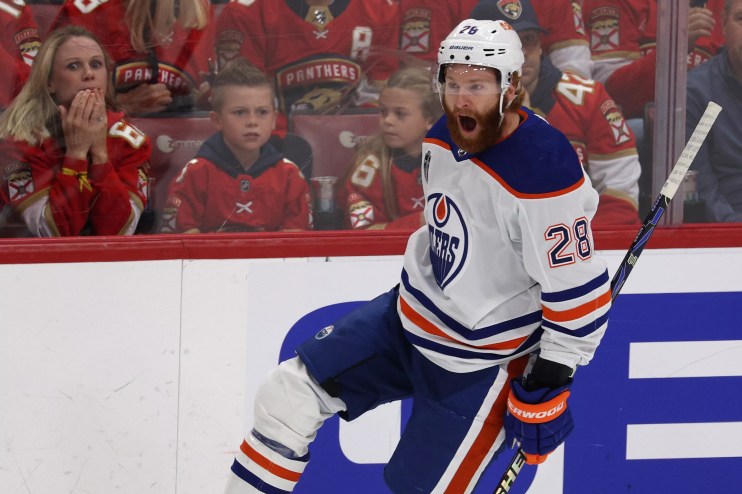 Connor Brown of the Edmonton Oilers skates off in celebration after scoring in the 2024 Stanley Cup Finals. The fans in the background look dejected
