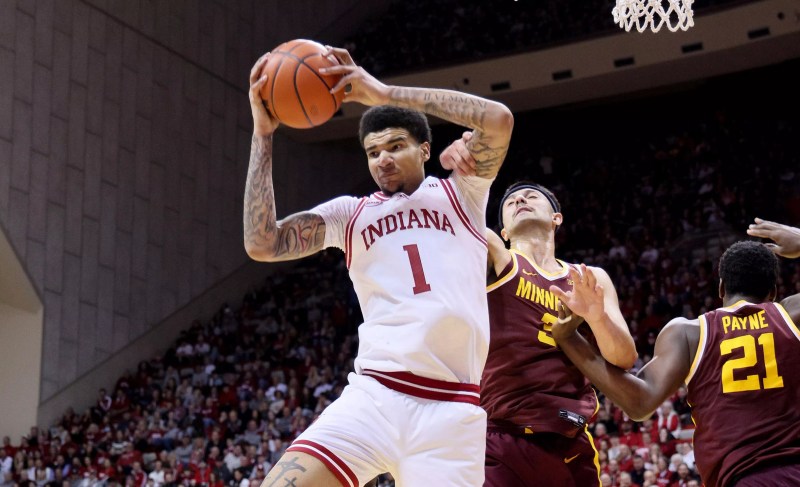 Kel'el Ware pulls in a rebound with a ball over his head