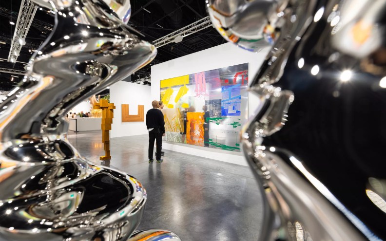 A man staring at a painting at Art Basel Miami Beach