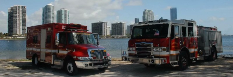 Miami Fire Rescue trucks parked near the water with the cityscape in the background