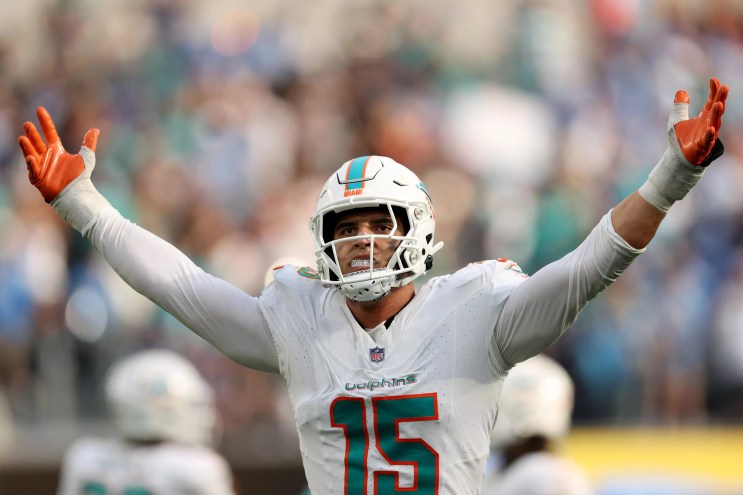 Dolphins linebacker Jaelan Phillips raises his hands in the air after a sack