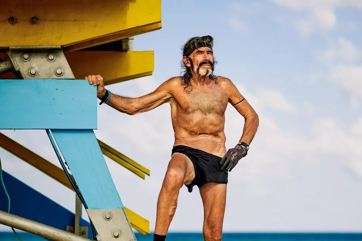 Robert "Raven" Kraft poses next to a lifeguard stand in Miami Beach