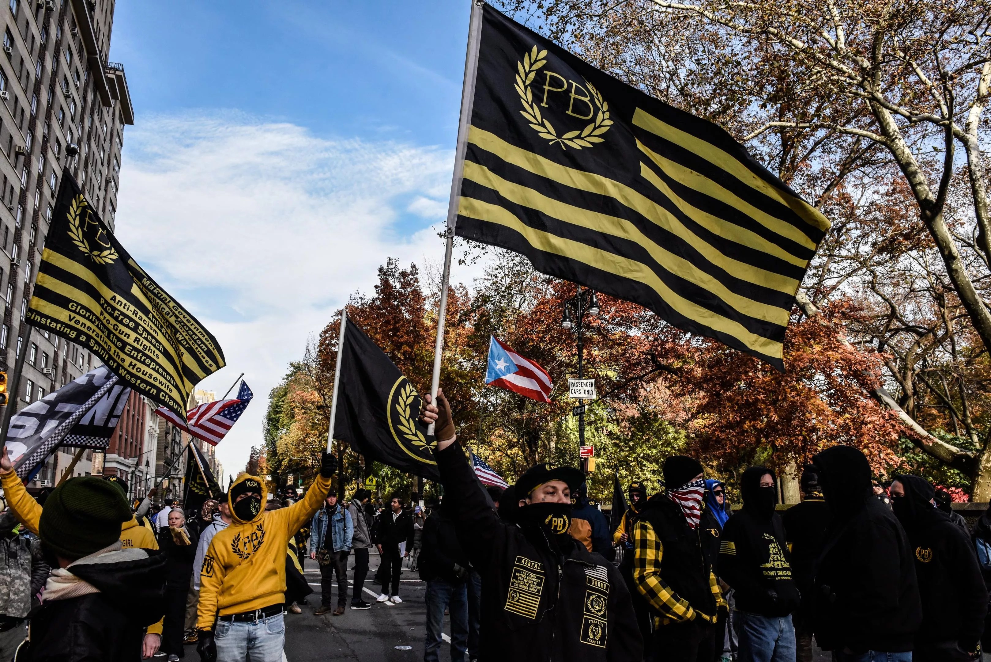 A Proud Boys rally with signature yellow-and-black flags waving