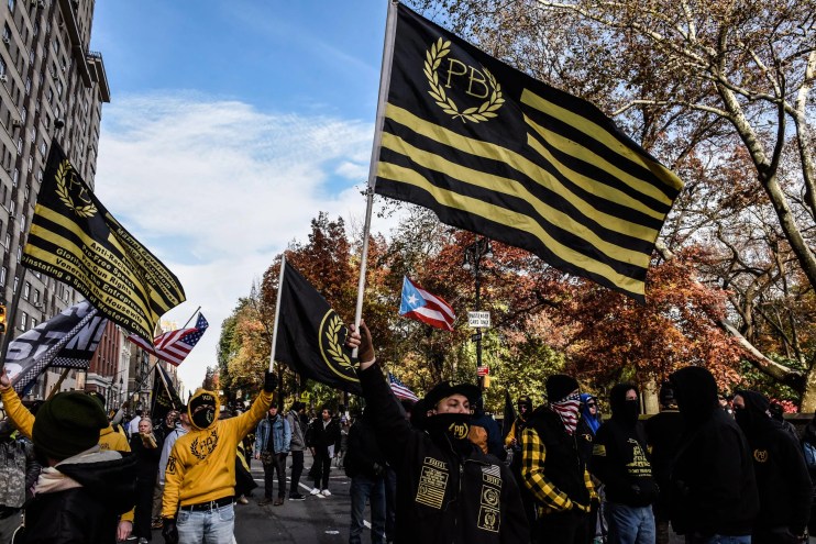 A Proud Boys rally with signature yellow-and-black flags waving