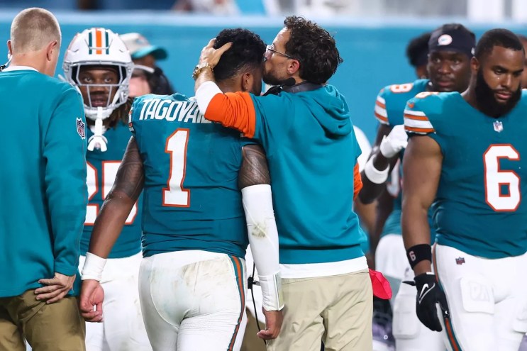 Head coach Mike McDaniel of the Miami Dolphins embraces Tua Tagovailoa #1 after leaving the game with an injury during the third quarter against the Buffalo Bills at Hard Rock Stadium on September 12, 2024 in Miami Gardens, Florida
