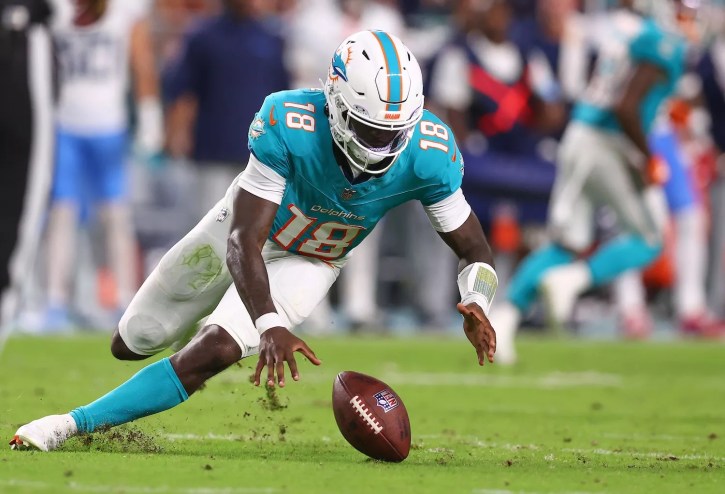 MIAMI GARDENS, FLORIDA - SEPTEMBER 30: Tyler Huntley #18 of the Miami Dolphins recovers a fumble against the Tennessee Titans during the second quarter at Hard Rock Stadium on September 30, 2024 in Miami Gardens, Florida