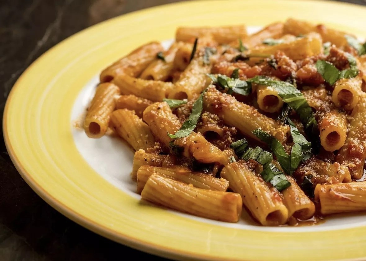 a pasta dish on a yellow plate