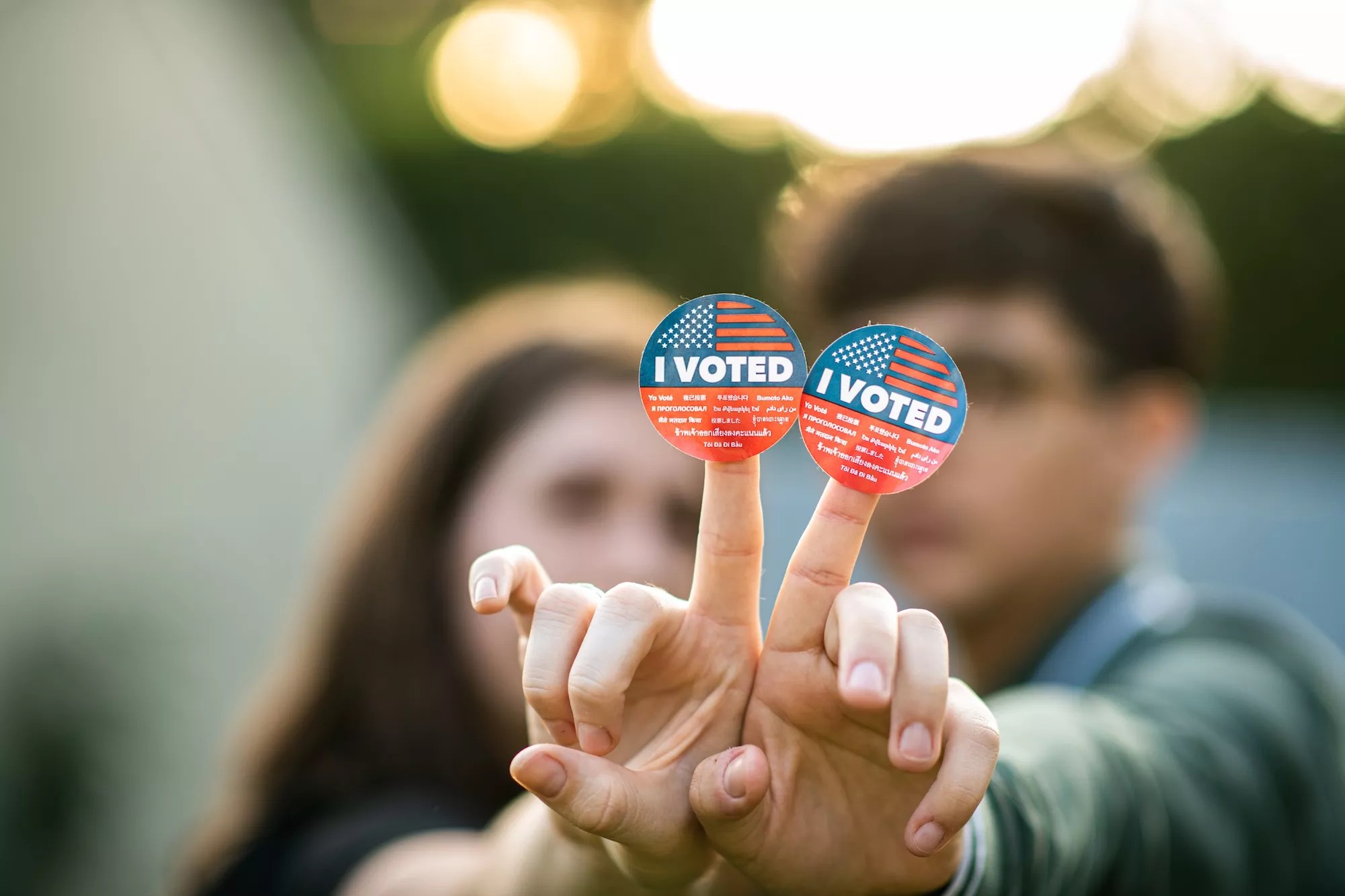 A couple holding up I Voted stickers.