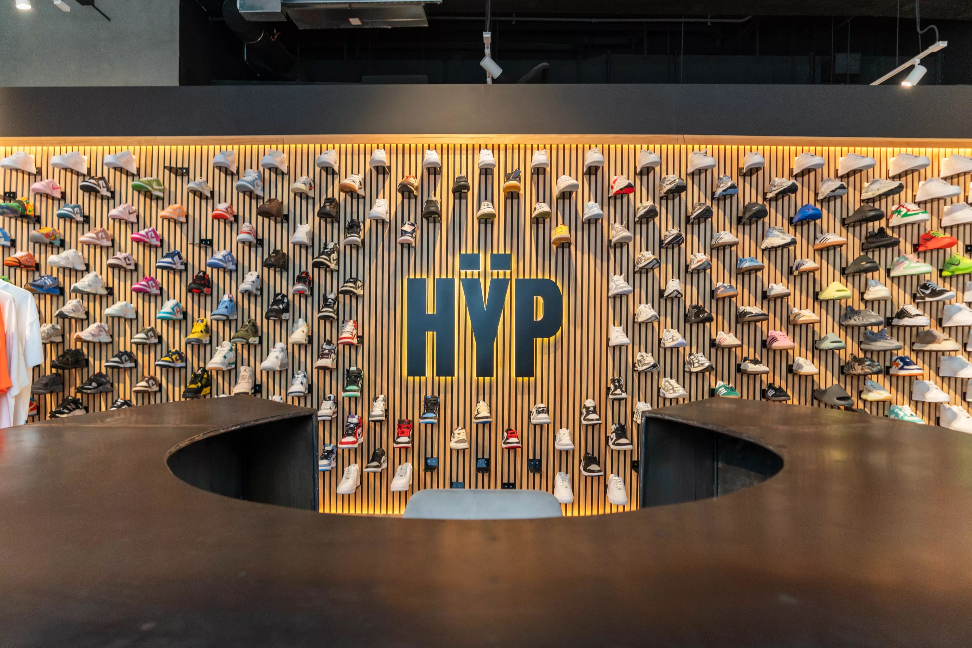 Wall display of colorful sneakers and the Hÿp logo inside the flagship store at Miami Worldcenter