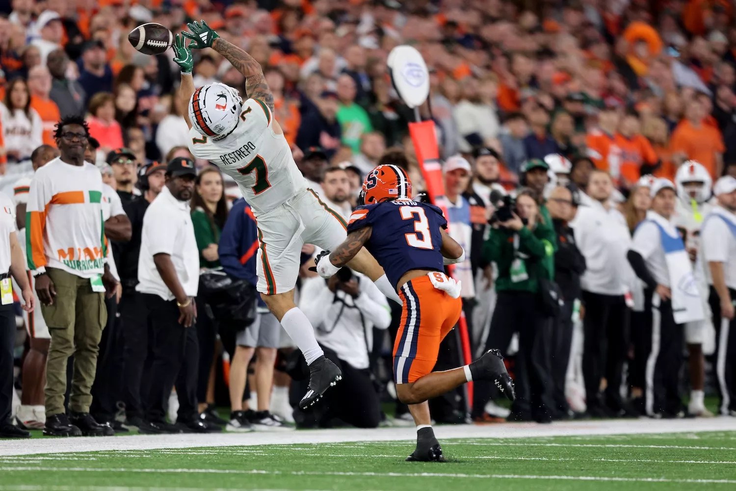 Xavier Restrepo #7 of the Miami Hurricanes attempts to catch a pass during the fourth quarter against the Syracuse Orange at JMA Wireless Dome on November 30, 2024, in Syracuse, New York.