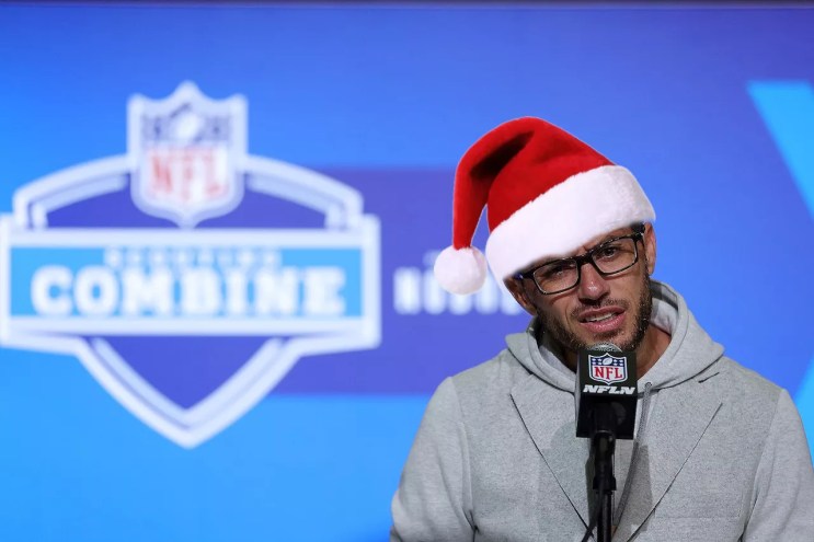 photo of Miami Dolphins head coach Mike McDaniel wearing a quizzical expression at an NFL combine press conference — with a Santa hat photoshopped onto his noggin
