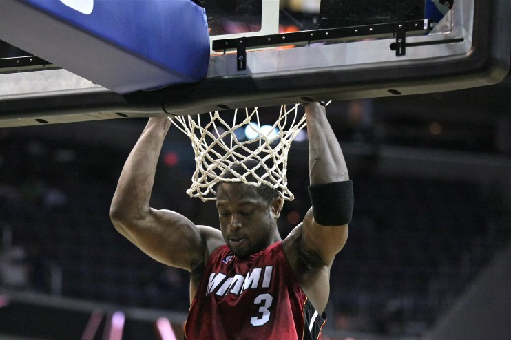 2009 photo of Dwyane Wade of the Miami Heat hanging off a basketball rim