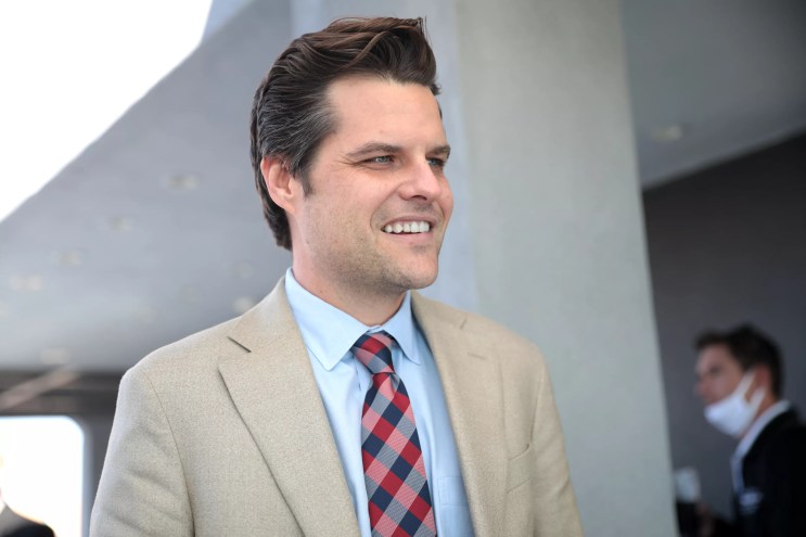 Matt Gaetz looking away from camera smiling.