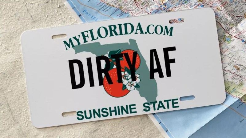 Florida license plate that reads, "DIRTY AF" laying on top of a map.