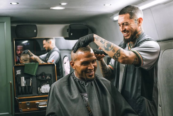 a barber cutting a client's hair